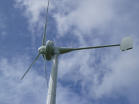 Wind Turbine against blue sky with white clouds